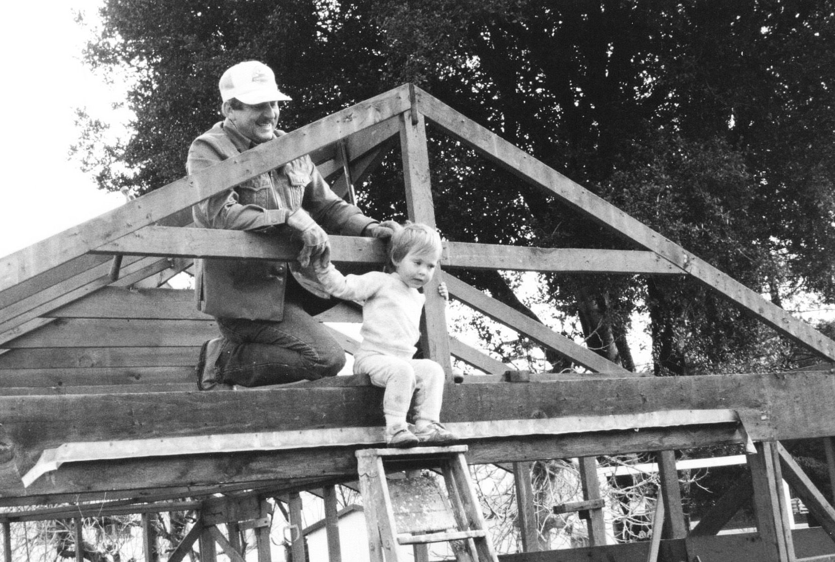 Grandpa & Jeremy Stephens on a ladder, working on a roof